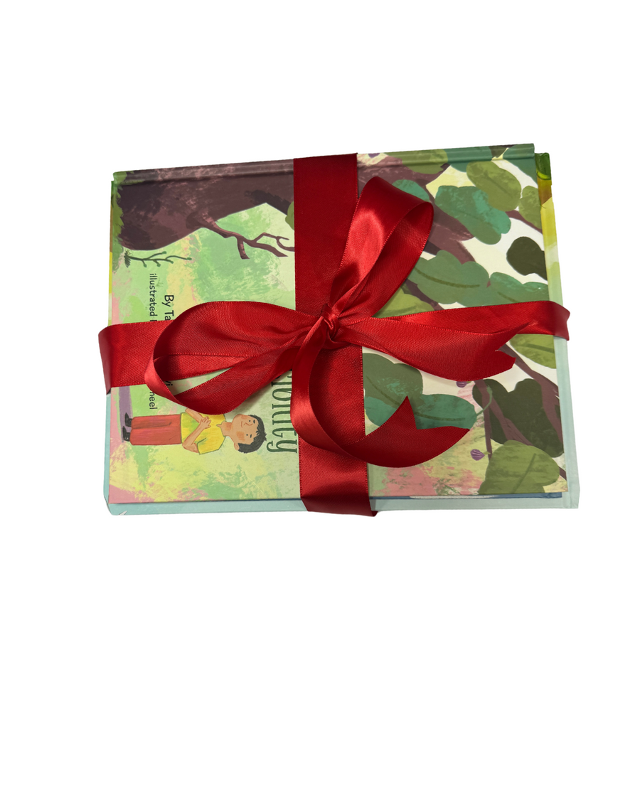 Gift-wrapped stack of hardcover Arabic children's books from Good Rain Publishing, featuring bilingual Palestinian stories for young readers